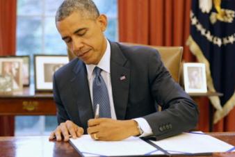 photo of President Obama signing the RESTORE Act